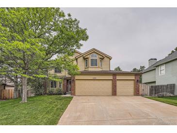 Charming two-story home with a large tree and a spacious three-car garage at 11522 Pine Grove Ln, Parker, CO 80138