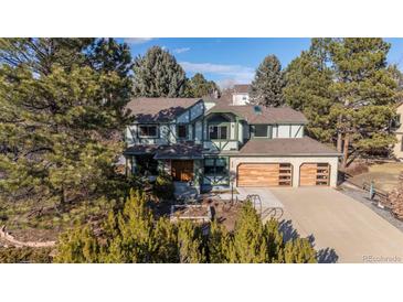 Charming two-story home with a three-car garage and beautiful landscaping in front at 8223 Kincross Way, Boulder, CO 80301
