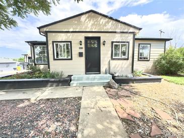 Charming single-story home with neutral siding and black trim, featuring a well-maintained front yard and inviting entrance at 8820 Poze Blvd, Thornton, CO 80229