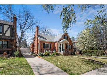 Charming brick home with well-maintained lawn, mature trees, and welcoming front porch offering classic curb appeal at 1615 Kearney St, Denver, CO 80220