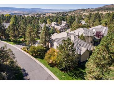 An overview of a lovely, peaceful neighborhood with well-maintained homes and green landscaping with mountain views at 3104 Ramshorn Dr, Castle Rock, CO 80108