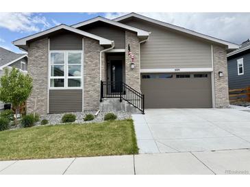 Charming single-Gathering home with brick accents, well-manicured lawn, and a two-car garage, creating excellent curb appeal at 5271 Routt Ct, Arvada, CO 80002