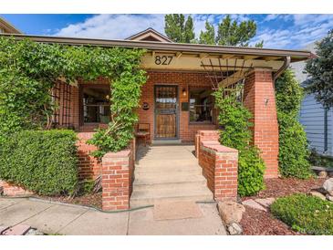 Charming brick home featuring a cozy front porch adorned with climbing greenery and a welcoming entrance at 827 S Sherman St, Denver, CO 80209