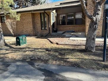 Charming home featuring a brick facade and well-kept yard, showcasing its inviting curb appeal at 8542 W 10Th W Ave, Lakewood, CO 80215