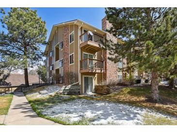 A view of the exterior of this 3 story condo with patios and a brick chimney at 3051 S Ursula Cir # 302, Aurora, CO 80014