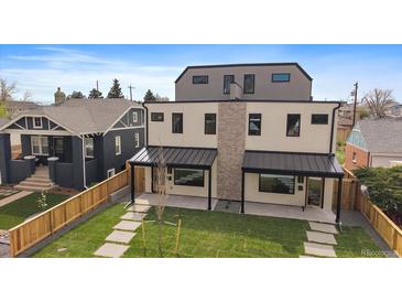 Contemporary two-story duplex with a manicured lawn and modern architectural details at 1423 Xavier St, Denver, CO 80204