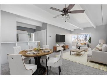 Bright living room featuring contemporary furnishings and a cozy dining area, perfect for entertaining at 1888 S Jackson St # 604, Denver, CO 80210
