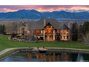 Stunning luxury home with mountain views, lakeside access, and impeccable landscaping at 1880 Mallard Dr, Broomfield, CO 80020