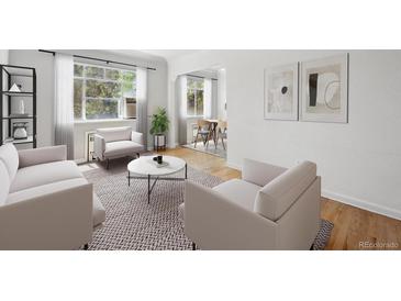 Bright living room with large windows and open floor plan to dining area offers comfort at 1130 N Pennsylvania St # 208, Denver, CO 80203