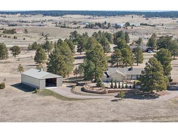 Sprawling property with a home, large storage structure, mature trees and a beautiful landscape in a serene, rural setting at 2287 Pinto Trl, Elizabeth, CO 80107