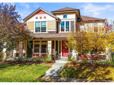 Beautiful two-story home with autumn landscaping and red front door at 9217 E 4Th Pl, Denver, CO 80230