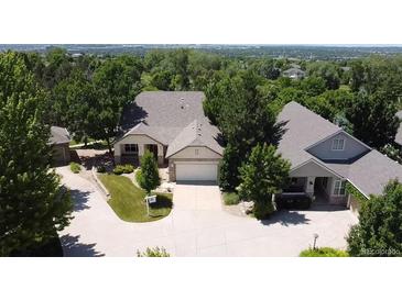 An aerial view of a home showcasing its well-manicured lawn, mature trees, and proximity to the golf course at 10619 N Osceola Dr, Westminster, CO 80031