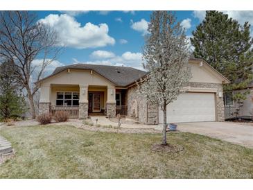 Charming single-story home with stone accents, mature trees, and a well-manicured lawn under a blue sky at 10619 N Osceola Dr, Westminster, CO 80031