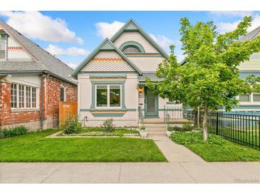 Charming home with a well-maintained lawn, attractive trim, and a cute tree in the front yard at 3613 Julian St, Denver, CO 80211
