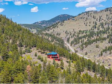 Secluded home nestled within a forest with mountain views at 5896 Peregrine Trl, Golden, CO 80403