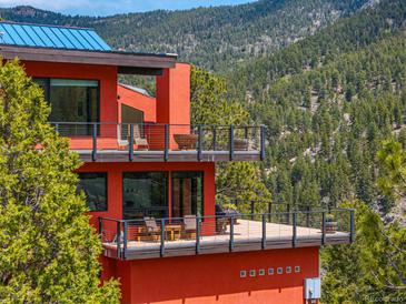 Modern red house with multiple balconies and mountain views at 5896 Peregrine Trl, Golden, CO 80403