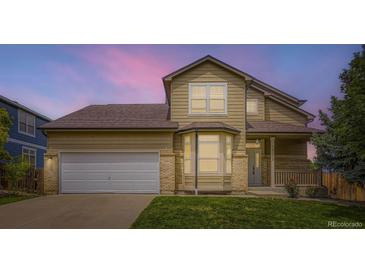 Charming home featuring a two-car garage and a well-manicured lawn at 19259 E Caspian Pl, Aurora, CO 80013