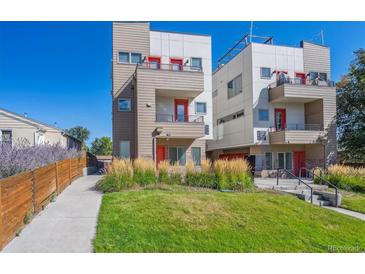 Modern two-story townhome with a walkway and grassy area at 1216 Perry St, Denver, CO 80204