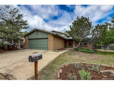 Charming brick home boasts a well-manicured front yard, mature trees, and a convenient two-car garage, creating curb appeal at 3722 Monterey Pl, Boulder, CO 80301