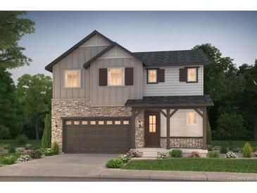 Charming two-story home featuring stone accents, a covered porch, and a well-maintained front yard at 2142 S Irvington St, Aurora, CO 80018