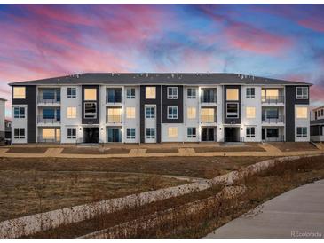 Modern apartment building exterior at dusk at 6153 N Ceylon St # 306, Denver, CO 80249