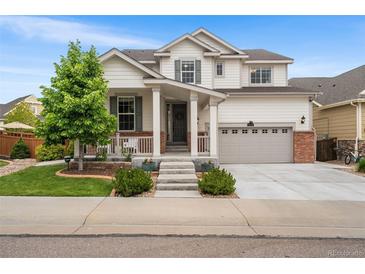 Charming two-story home with a well-maintained front yard, covered porch, and a two-car garage in a suburban neighborhood at 2679 Leafdale Cir, Castle Rock, CO 80109