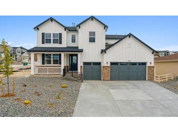 Charming two-story home with a three-car garage and covered porch at 4741 Twelve Oaks Way, Castle Rock, CO 80104