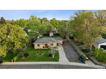 Charming brick home with a well-maintained front yard and mature trees offering great curb appeal at 6390 W 47Th Ave, Wheat Ridge, CO 80033