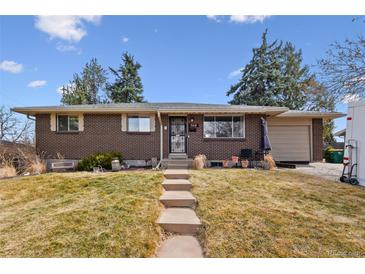 Charming brick home with a well-maintained front yard and inviting walkway to the front door at 5118 S Osceola St, Littleton, CO 80123