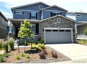 Beautiful two-story home featuring stone accents, an attached two-car garage, and a well-maintained front yard at 3945 John Ave, Castle Rock, CO 80104