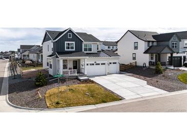 Charming two-story home with a three-car garage and landscaped front yard at 1308 E Hopkins Dr, Elizabeth, CO 80107