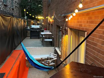 Cozy patio with string lights, grill, hammock and outdoor seating for relaxing and entertaining at 1421 N Pearl St # 2, Denver, CO 80203