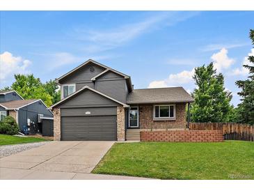 Charming two-story home featuring a well-maintained lawn, brick accents, and a spacious two-car garage in a quiet neighborhood at 10859 W Fair Ave, Littleton, CO 80127