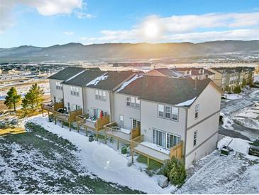 Aerial view of three-story townhouses with private decks and mountain views at 909 Burning Bush Pt, Monument, CO 80132