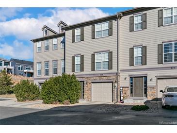 Inviting townhome featuring a neutral exterior, two-car garage, and well-maintained landscaping at 909 Burning Bush Pt, Monument, CO 80132