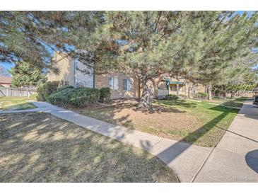Inviting condo with mature landscaping and a well-maintained lawn at 15136 E Louisiana Dr # 106, Aurora, CO 80012