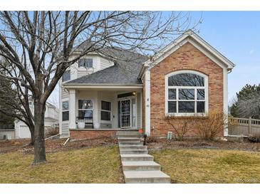 Charming two-story home with a brick facade and a welcoming front porch and well maintained yard at 1011 S Valentia St # 43, Denver, CO 80247