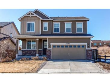 Two-story house with attached garage and landscaping at 9685 Bellaire Ln, Thornton, CO 80229