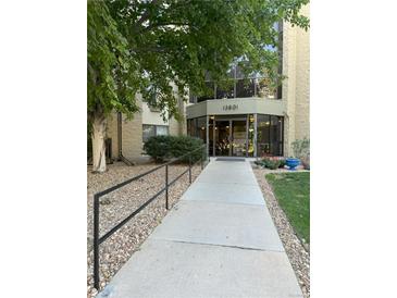 Well maintained building entrance with clean walkway and attractive landscaping at 13601 E Marina Dr # 510, Aurora, CO 80014