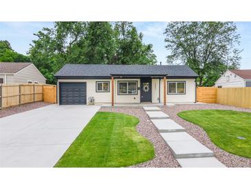 Charming single story home with well-manicured lawn, walkway, garage and neutral exterior at 3061 S Glencoe St, Denver, CO 80222