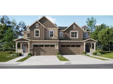 Charming two-story home with a two car garage and a well-manicured lawn at 6751 Arbor E Blvd, Thornton, CO 80602