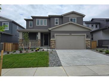 Charming two-story home featuring a two-car garage, welcoming porch, and well-maintained front yard and landscaping at 1290 Loraine N Cir, Lafayette, CO 80026