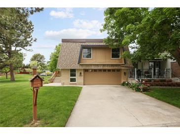 Charming home featuring a well-manicured lawn, two-car garage, and inviting curb appeal at 141 S Upham Ct, Lakewood, CO 80226