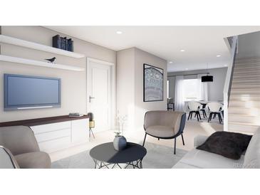 Inviting living room featuring sleek furniture, modern media center, and open layout to dining area at 3728 W 1St Ave, Denver, CO 80219