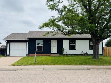Charming single Gathering home boasts a well manicured front yard and an attached garage at 4312 S Xenon St, Morrison, CO 80465