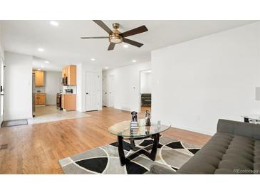 Open-concept living room leading to a modern kitchen and dining area, perfect for entertaining and Gathering gatherings at 9101 Clarkson St, Thornton, CO 80229
