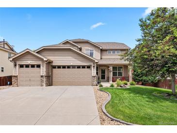Charming two-story home featuring a three-car garage, well-maintained lawn and mature landscaping at 12942 Leyden St, Thornton, CO 80602