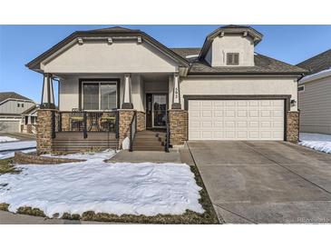 Two-story home with attached two-car garage and front porch at 592 Bristolwood Ln, Castle Pines, CO 80108