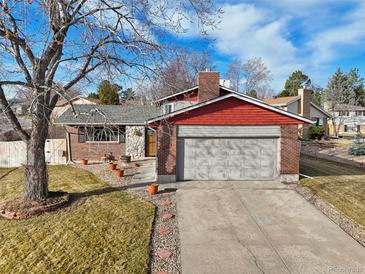 Charming single-Gathering home with a two-car garage, brick facade, and well-manicured lawn at 4080 E Caley Cir, Centennial, CO 80121