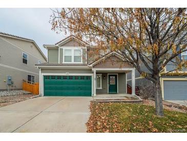 Two-story house with green garage door and landscaping at 2389 Quartz St, Castle Rock, CO 80109